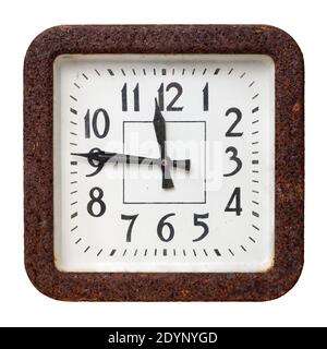 Very old retro rectangular wall clock, with white face and heavily corroded metal frame, isolated on white background Stock Photo