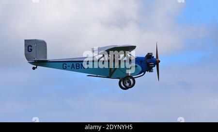 Vintage 1931 Civilian Coupe 02 G-ABNT  aircraft in flight  with blue sky and clouds. Stock Photo