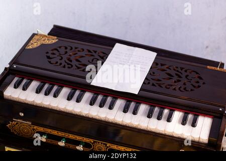 Harmonium or organ and musical notes in bengali language on white background Stock Photo