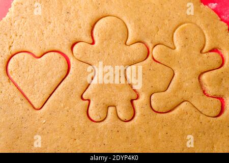 Cutting gingerbread shapes. Family or love couple concept from dough for St. Valentines Day.  Stock Photo