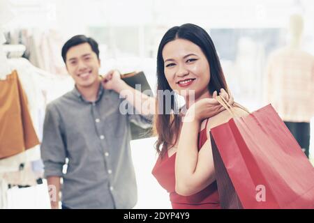 Happy young couple enjoying spending weekend shopping together for Christmas Stock Photo