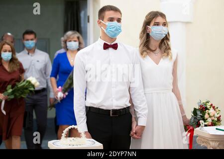 Marriage. Bride and groom wearing medical masks. Getting married during the coronavirus pandemic. Stock Photo