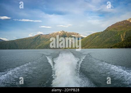 wake behind a power boat in deep water creek Stock Photo