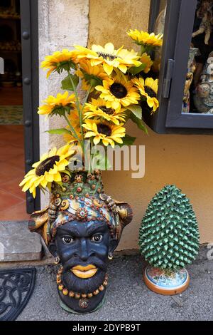 African Looking Ceramic Vase Full Of Sunflowers Outside A Shop In Taormina On The Island Of Sicily Stock Photo