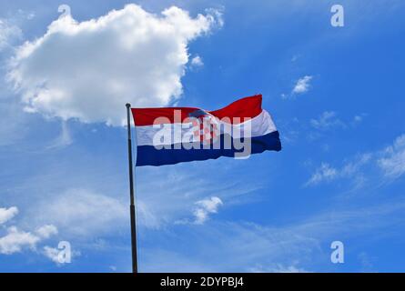 Croatian Flag against blue sky with clouds Stock Photo