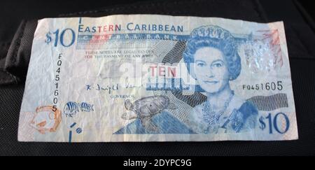 A closeup shot of eastern  Caribbean ten dollars banknote on the black background Stock Photo