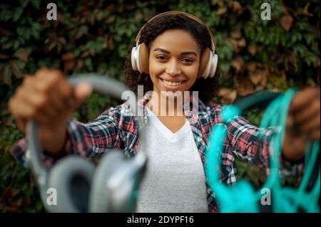 Music fan in headphones listening to music in park Stock Photo