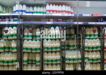 12-27-2020 Portsmouth, Hampshire, UK A supermarket fridge stocking various size cartons of milk for sale Stock Photo