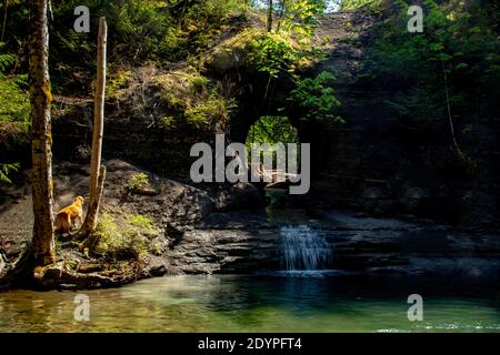 Peaceful waterfall created by drilling through the rock face. Hole in the wall is an artificial waterfall created on a large rock near Port Alberni in Stock Photo