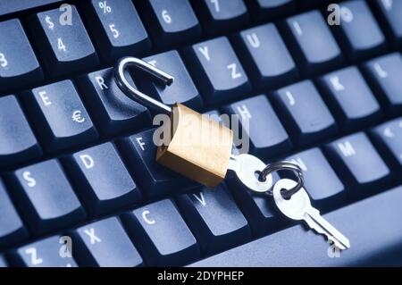 Unlocked metal padlock with keys on blue computer keyboard. Data and password protection, internet and network security concept. Stock Photo