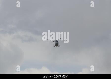 Helicopter landing in open field in Africa, delivering humanitarian help Stock Photo