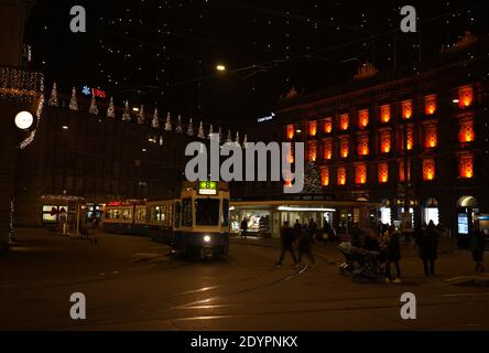 Paradeplatz at christmastime at night. Illuminated windows of headquarter of banks and tram station in Zurich with many hanging lamps called Lucy. Zur Stock Photo