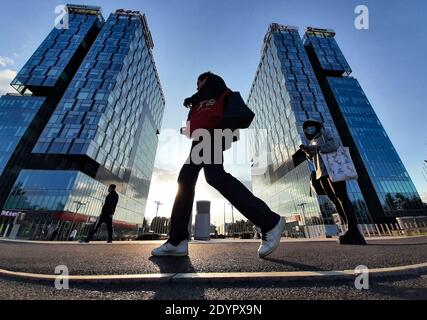 Bucharest, Romania - October 19, 2020: People walk in front of the City Gate Towers situated in Free Press Square, in Bucharest. Stock Photo