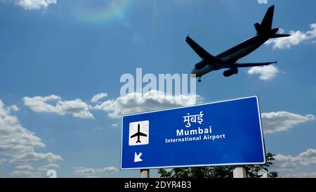 Airplane landing in Mumbai, Bombay, India, Maharashtra. City arrival with international airport direction signboard and sky in background. Travel, tri Stock Photo