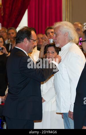 French President Francois Hollande awards singer Hugues Aufray with the Order of Chevalier de la Legion d'Honneur during a ceremony at the Elysee Palace in Paris, France on July 3, 2013. Photo by Pierre Villard/Pool/ABACAPRESS.COM Stock Photo