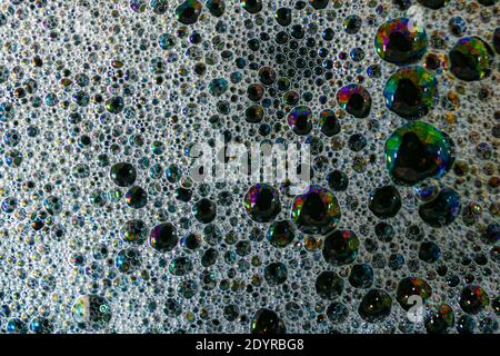 Shot from above of soap bubbles with brilliant oil colors, caused by interference of light Stock Photo