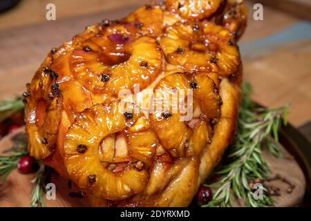 A delicious pineapple glazed ham in a Christmas setting. Stock Photo