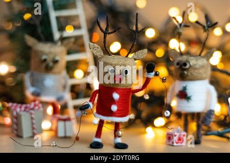 Creative Christmas Concept Winter Festive Cork deer figures celebrating Boxing Day in Santa suit Scandinavian concept recycled Christmas ornaments Stock Photo