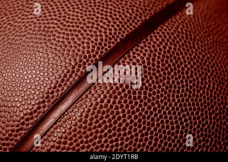 Closeup detail of basketball ball texture background. Red color filter. Banner art concept. Team sport Stock Photo