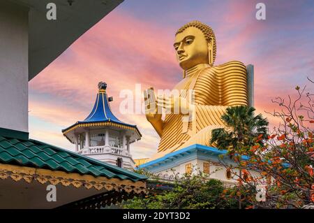 Golden Buddha statue in Dambulla Temple in Sri Lanka at sunset Stock Photo