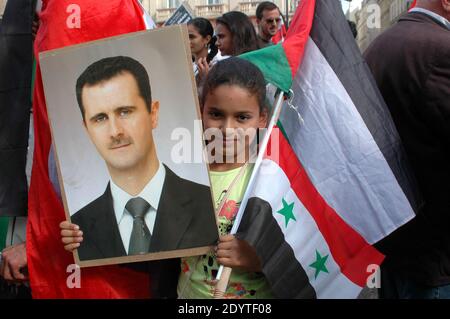Demonstrators raise portraits of Syrian President Bashar al-Assad in Paris, France, on September 8, 2013, to protest against a potential military strike against Syria. Syrian President Bashar al-Assad has denied in an interview with CBS television that he was behind a chemical attack last month and called on lawmakers to reject planned US military strikes, the US network said on September 8. Photo by Alain Apaydin/ABACAPRESS.COM Stock Photo