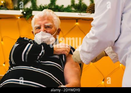Beijing, Germany. 27th Dec, 2020. A resident of the Senior Centre Riehl receives an injection with a dose of COVID-19 vaccine in Cologne, Germany, Dec. 27, 2020. Vaccinations in Germany started on Sunday. All citizens over 80 years of age as well as residents and staff of nursing homes would be among the first to get vaccinated, according to Germany's Minister of Health Jens Spahn at a press conference held on Dec. 19. Credit: Tang Ying/Xinhua/Alamy Live News
