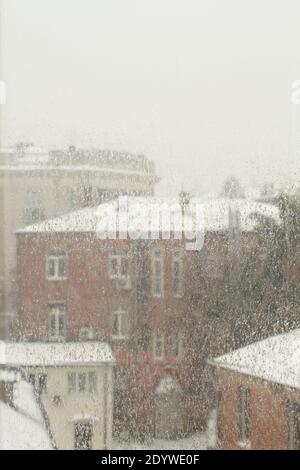 Street view through an ice-covered window outside. Dull cloudy winter day. Stock Photo