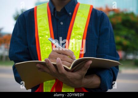 Engineer write take note on book for planing work Stock Photo