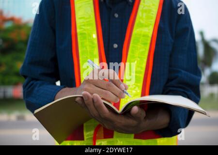 Engineer write take note on book for planing work Stock Photo