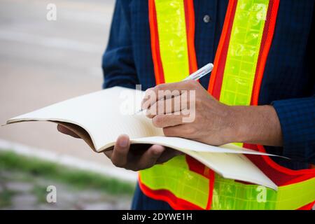 Engineer write take note on book for planing work Stock Photo