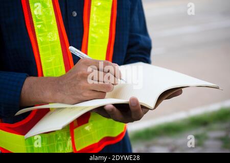 Engineer write take note on book for planing work Stock Photo