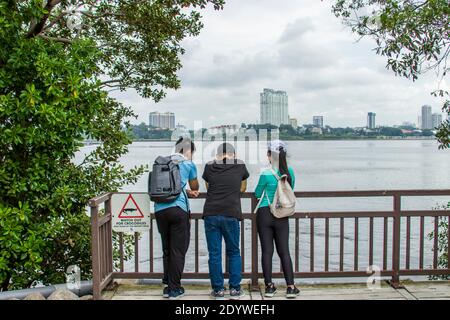 Warning sign board to remind tourist to watch out for crocodiles in Sungei Buloh Wetland Reserve Singapore. The background is JOHOR BAHRU Malaysia. Stock Photo