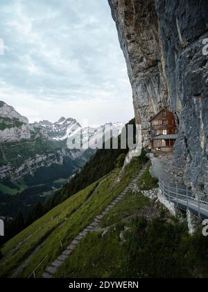 Famous guesthouse Aescher-Wildkirchli built into limestone cliff wall Alpstein alpine mountains Appenzell Innerrhoden Switzerland Stock Photo