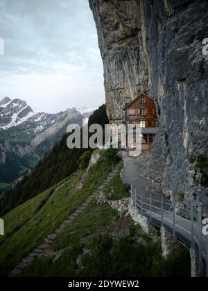 Famous guesthouse Aescher-Wildkirchli built into limestone cliff wall Alpstein alpine mountains Appenzell Innerrhoden Switzerland Stock Photo