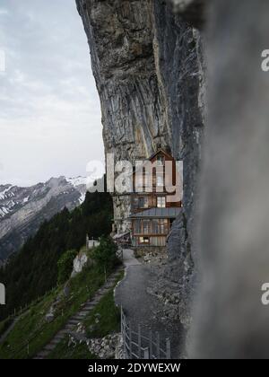 Famous guesthouse Aescher-Wildkirchli built into limestone cliff wall Alpstein alpine mountains Appenzell Innerrhoden Switzerland Stock Photo