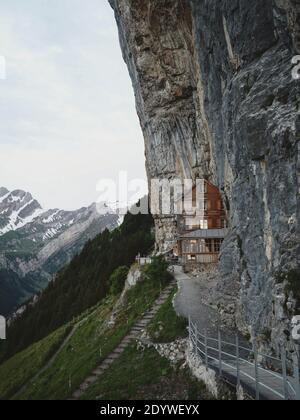 Famous guesthouse Aescher-Wildkirchli built into limestone cliff wall Alpstein alpine mountains Appenzell Innerrhoden Switzerland Stock Photo