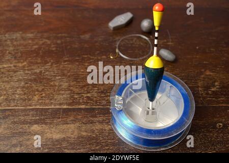 Fishing accessories on wooden plate Stock Photo