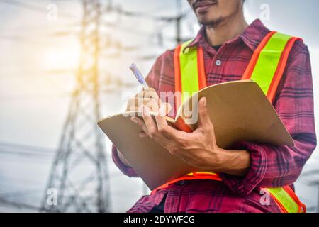 Engineer writing on notebook at work Stock Photo