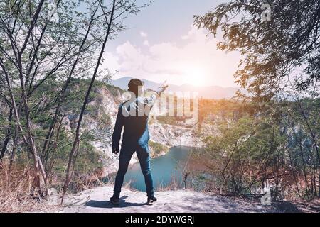 Man standing on rock mountain at sky view background copy spec,travel Stock Photo