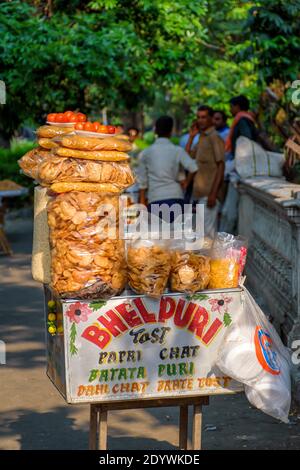 Papri chat, bhel puri and wide variety of chats being sold by a fast food vendor in his cart beside a road in Kolkata, India on May 2019 Stock Photo