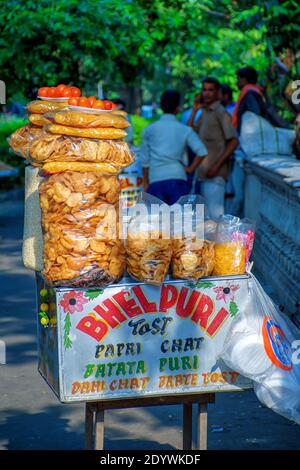 Papri chat, bhel puri and wide variety of chats being sold by a fast food vendor in his cart beside a road in Kolkata, India on May 2019 Stock Photo