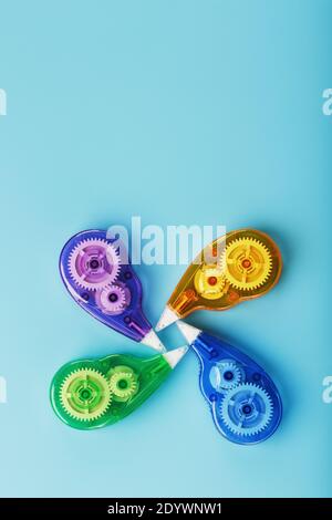 Multi-colored Stationery correction tapes on a blue background. Free space. The view from the top Stock Photo