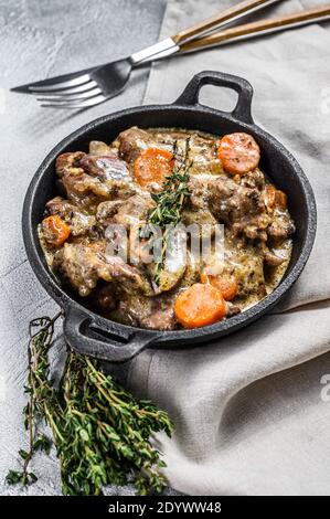 Baked Chicken liver, offal with onions in a frying pan. White background. Top view Stock Photo