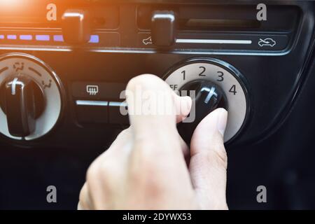 People are adjusting fans of car air conditioning while parked on hot roads. Stock Photo