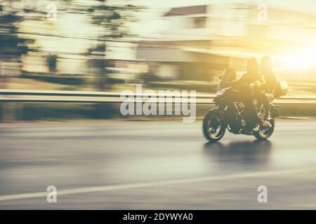 Blurry subject motorcycle driving on road Stock Photo