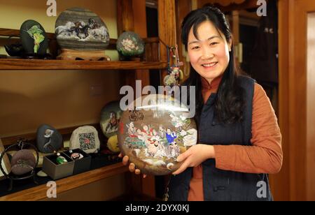 December 28, 2020, Yantai, Yantai, China: Shandong,CHINA-A fishing girl from Yantai city, Shandong Province, who has loved painting since childhood, started to create stone paintings on her collection of Ball stones on Changdao Island in 2017...A picture of animals, landscape paintings and other show on the stone, small and lovely, lifelike...Many friends came to order. (Credit Image: © SIPA Asia via ZUMA Wire) Stock Photo