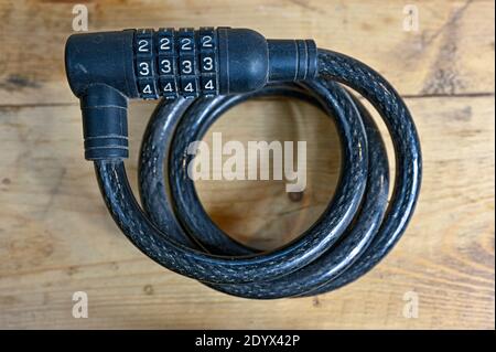 wire with combination lock for bikes rolled up Stock Photo