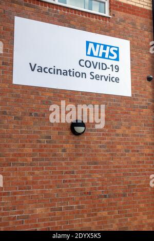 NHS Covid-19 Vaccination Service sign on a wall Stock Photo