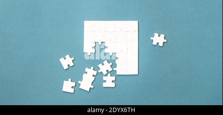 Small white square puzzle on a blue background Stock Photo
