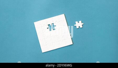 Small white square puzzle on a blue background Stock Photo